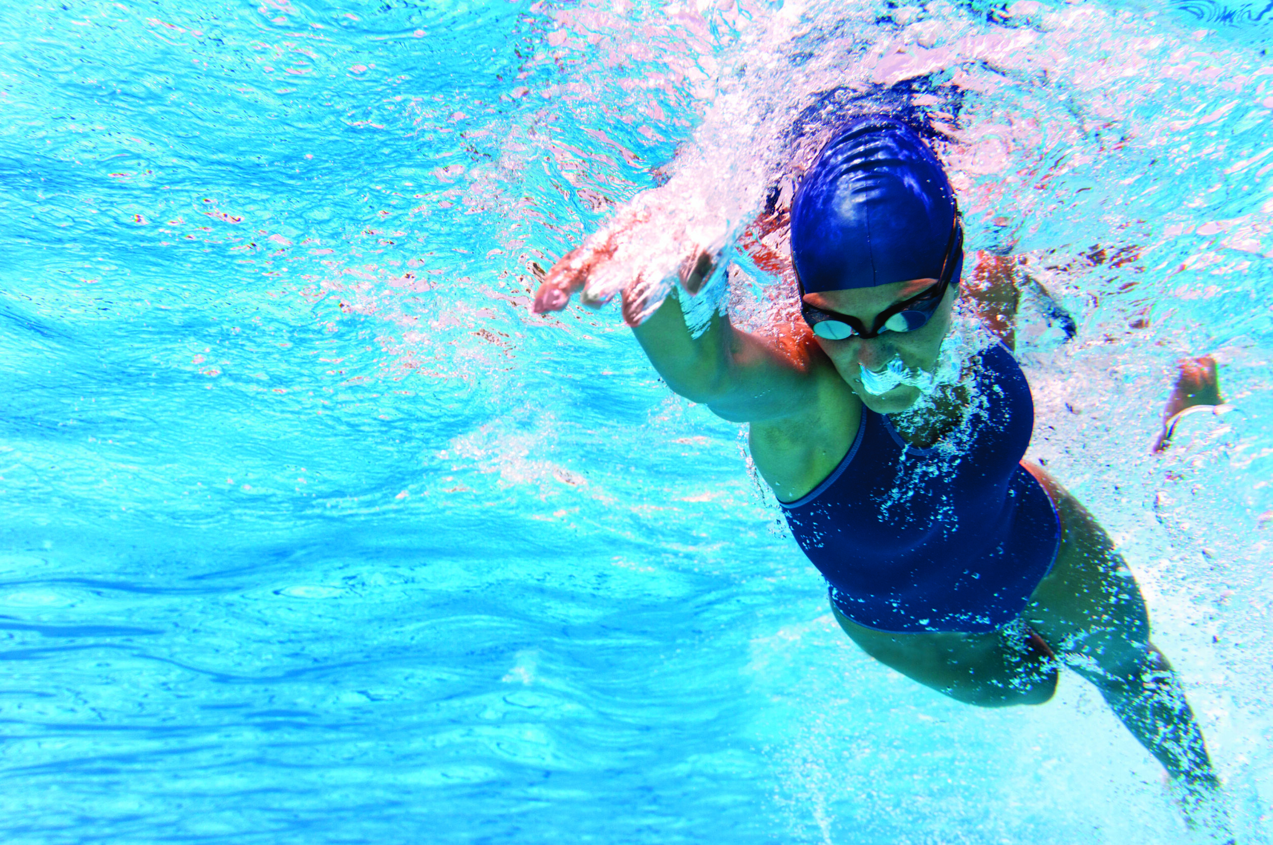 Underwater photo of female swimmer swimming freestyle
